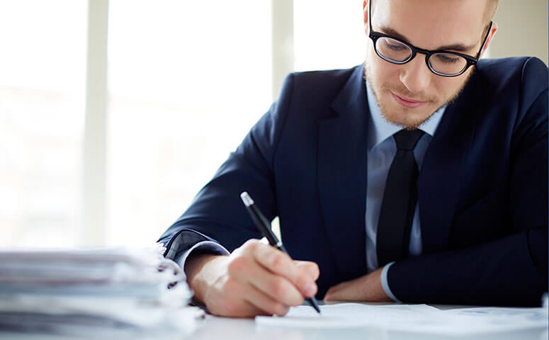 Businessman in glasses works on contract