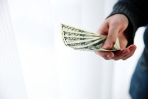 Man holding money - blog posting image https://www.tatonkare.com/