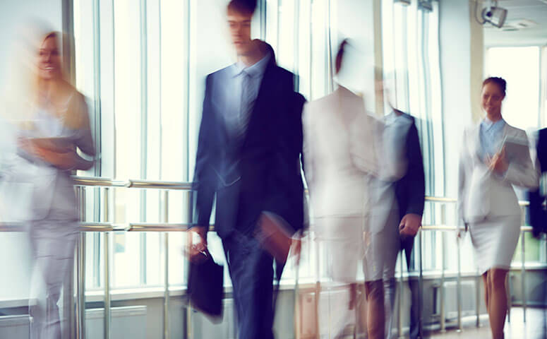 Random passerbys walking through an office building