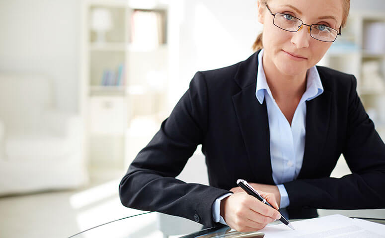 Female in suit works on lease document