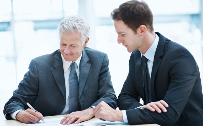 Two businessmen signing a contract